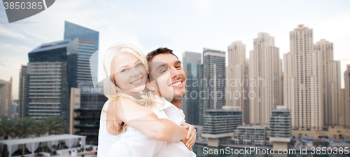 Image of happy couple having fun over dubai city background