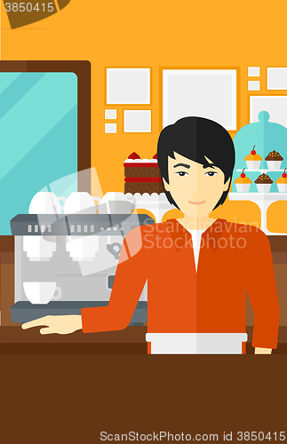 Image of Barista standing near coffee maker.