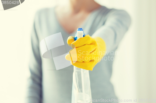 Image of close up of happy woman with cleanser spraying