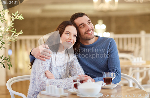 Image of happy couple drinking tea at restaurant