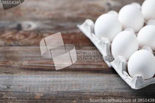 Image of White chicken eggs on old wooden table