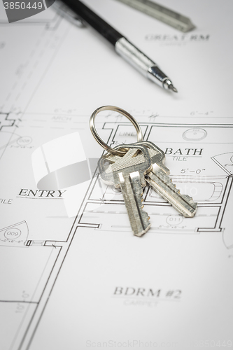 Image of Engineer Pencil, Ruler and Keys Resting On House Plans