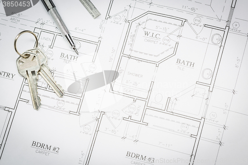 Image of Engineer Pencil, Ruler and Keys Resting On House Plans
