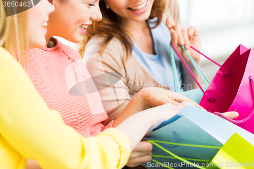 Image of close up of happy teenage girls with shopping bags