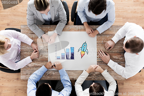 Image of close up of business team sitting at table