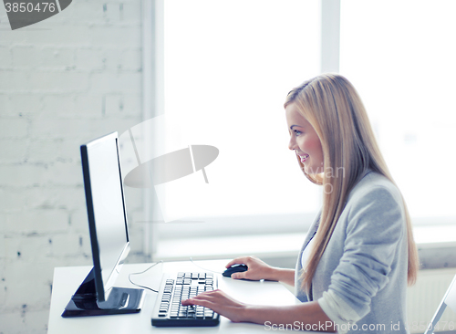 Image of businesswoman with computer in office