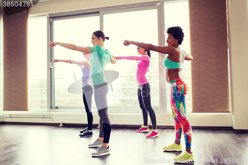 Image of group of happy women working out in gym