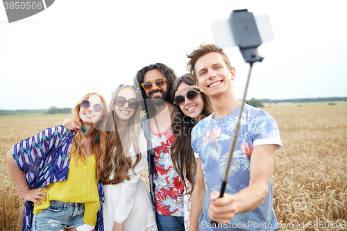 Image of hippie friends with smartphone on selfie stick