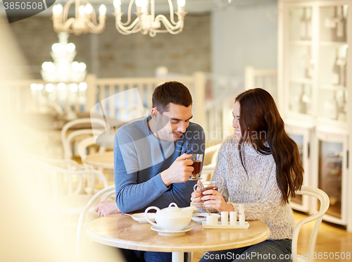Image of happy couple drinking tea at cafe