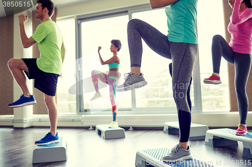 Image of group of people raising legs on step platforms