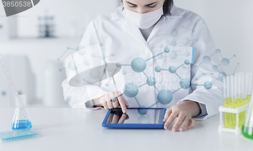 Image of close up of scientist with tablet pc in laboratory