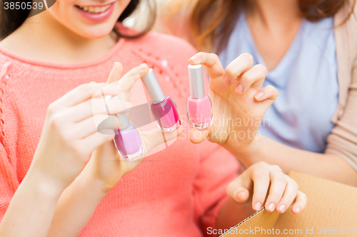 Image of close up of smiling young woman with nail polish