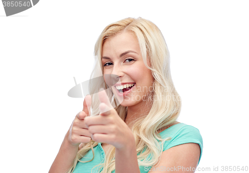 Image of happy young woman pointing finger to you