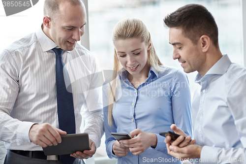 Image of business people with tablet pc and smartphones