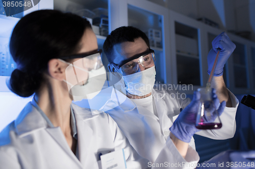 Image of close up of scientists making test in lab