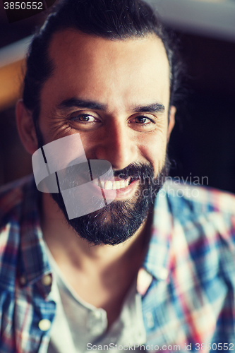 Image of happy young man with beard and mustache