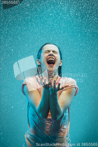 Image of The portrait of young beautiful woman in the rain