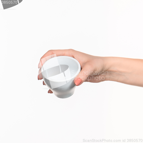 Image of Woman hand with cup on white background