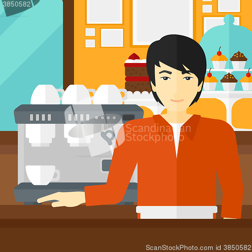 Image of Barista standing near coffee maker.