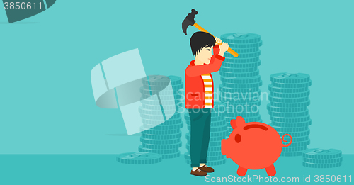 Image of Man breaking piggy bank.