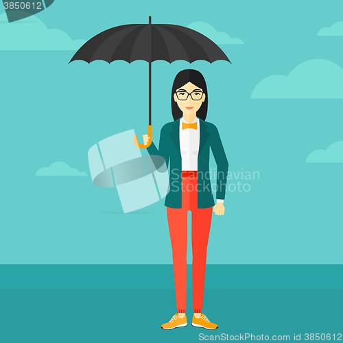 Image of Business woman standing with umbrella.