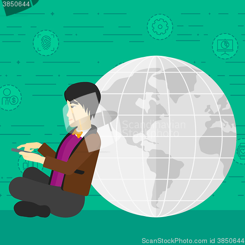 Image of Man sitting near globe.