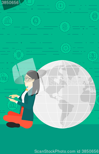 Image of Woman sitting near globe.