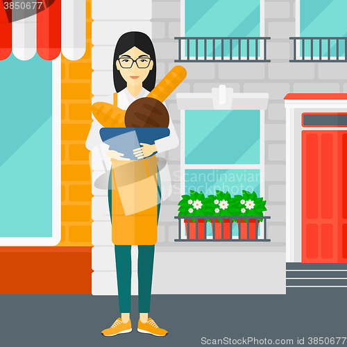 Image of Bakery owner with bread.