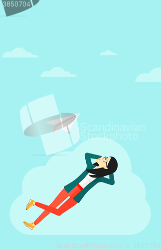 Image of Business woman relaxing on cloud.