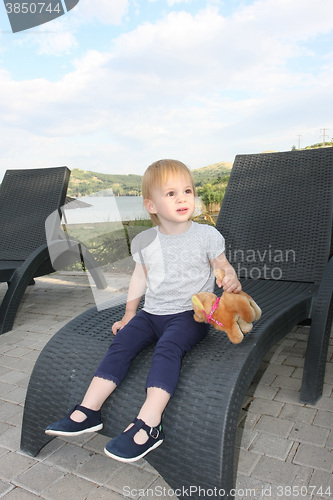 Image of Little girl in easy chair