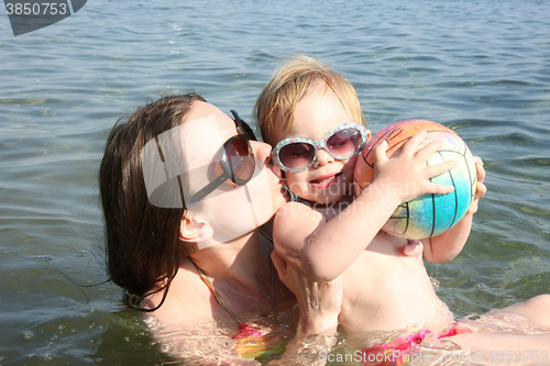 Image of Mother and daughter playing in the sea