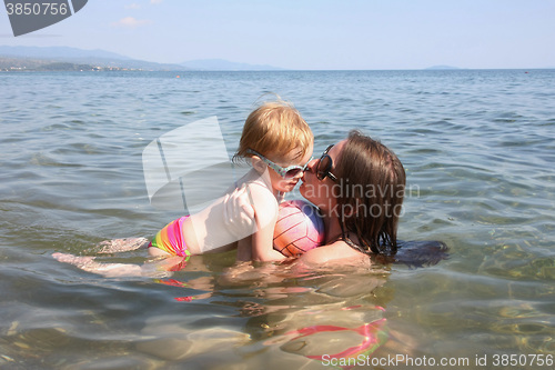 Image of Mother and daughter playing in the sea