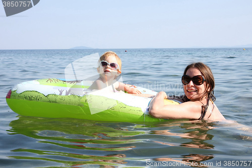 Image of Mother and daughter floating in the sea