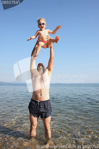 Image of Father playing with his baby girl