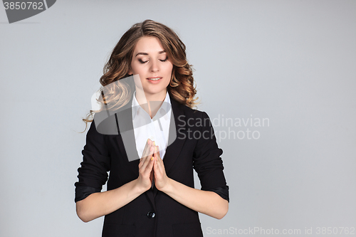 Image of Woman is looking imploring over gray background