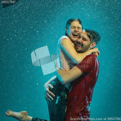 Image of The loving couple in the rain