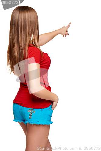 Image of Back view of a young female pointing at blank copy space