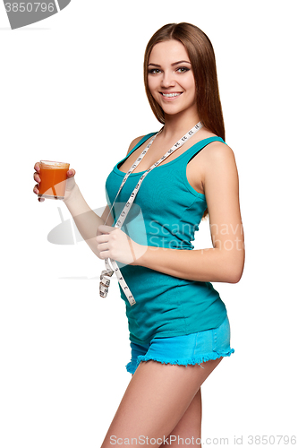 Image of Happy teen girl holding a glass of carrot juice