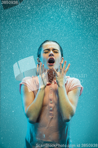 Image of The portrait of young beautiful woman in the rain