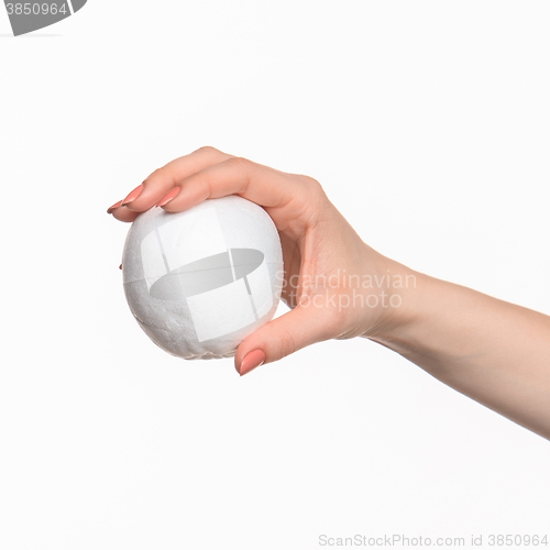 Image of The female hand holding white blank styrofoam oval 