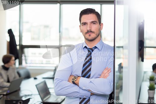 Image of Team leader with coworkers working in office.