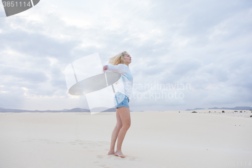 Image of Carefree woman enjoying freedom on beach.