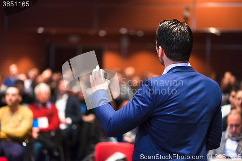 Image of Public speaker giving talk at Business Event.