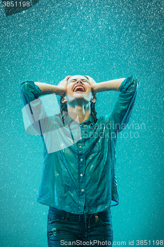 Image of The portrait of young beautiful woman in the rain