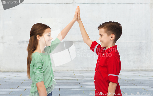 Image of happy boy and girl making high five