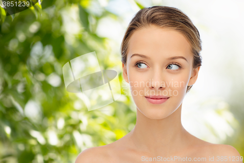 Image of smiling young woman face and shoulders