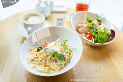 Image of close up of pasta in bowl on table at restaurant