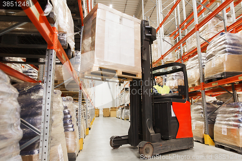 Image of man on forklift loading cargo at warehouse