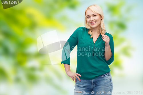 Image of smiling young woman in shirt and jeans