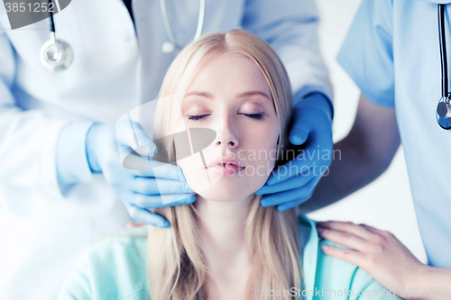 Image of plastic surgeon or doctor with patient